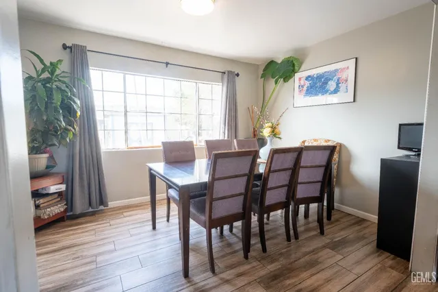 a dining room with furniture and wooden floor