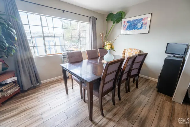 a view of a dining room with furniture and wooden floor