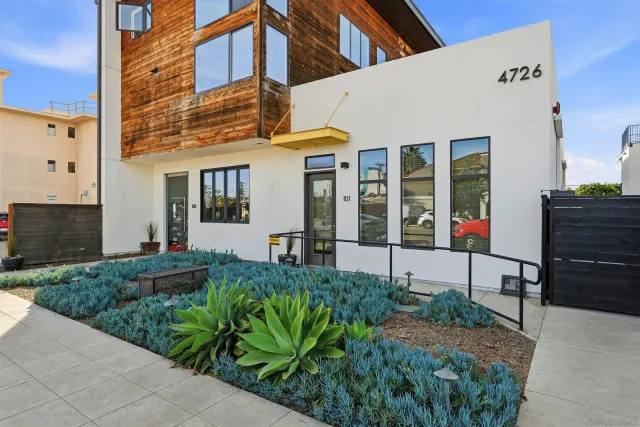 a view of a house with potted plants