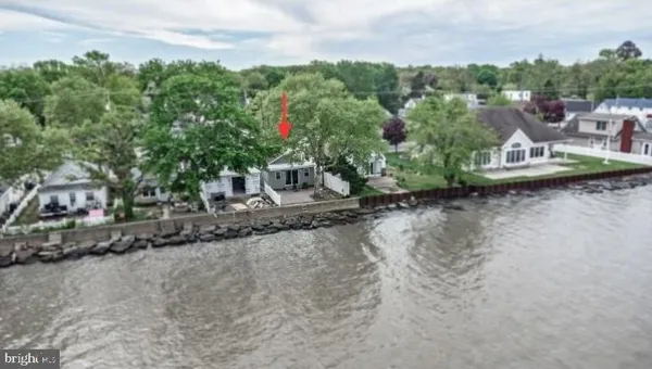 an aerial view of a house with a yard and lake view