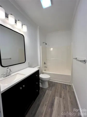 a bathroom with a double vanity sink toilet and mirror