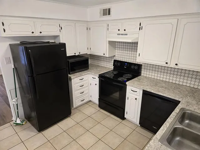 a kitchen with a sink stove and refrigerator