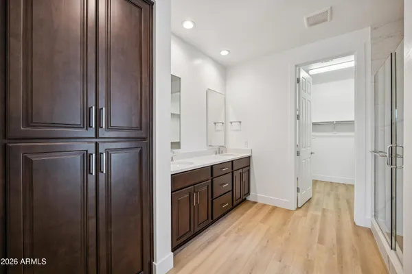 a view of hallway with cabinets and wooden floor
