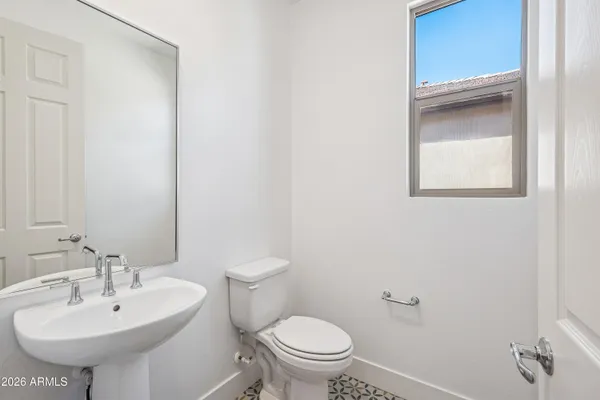 a bathroom with a sink toilet and a mirror