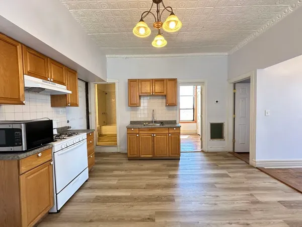 a kitchen with stainless steel appliances granite countertop a stove and cabinets