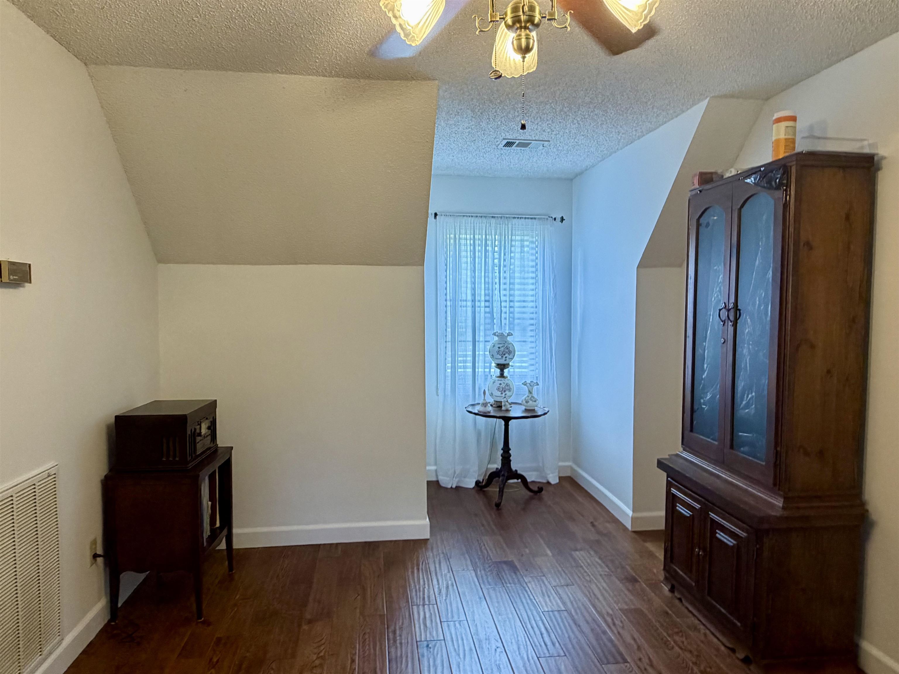 142 Treece Street Selmer, TN 38375 - Photo 16 of 36 Interior space featuring wood-finish flooring, white walls, and a window with blinds