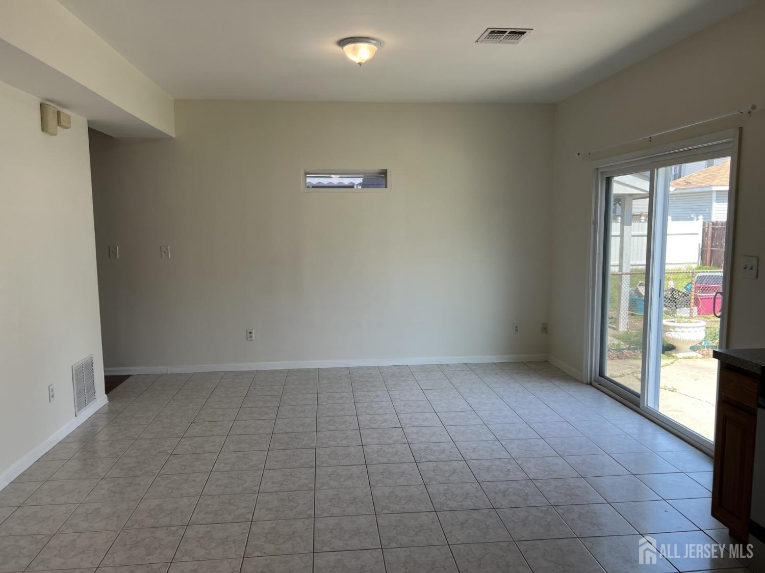 22 North Whittier Street, Unit B Carteret, NJ 07008 - Photo 14 of 27 wooden floor in an empty room with a window