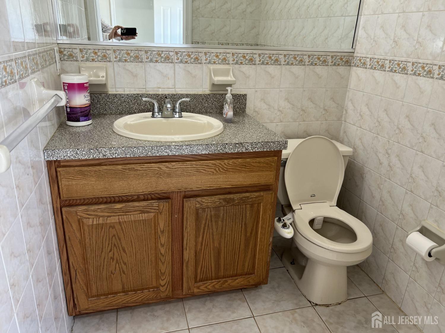 22 North Whittier Street, Unit B Carteret, NJ 07008 - Photo 17 of 27 a bathroom with a granite countertop toilet sink and mirror