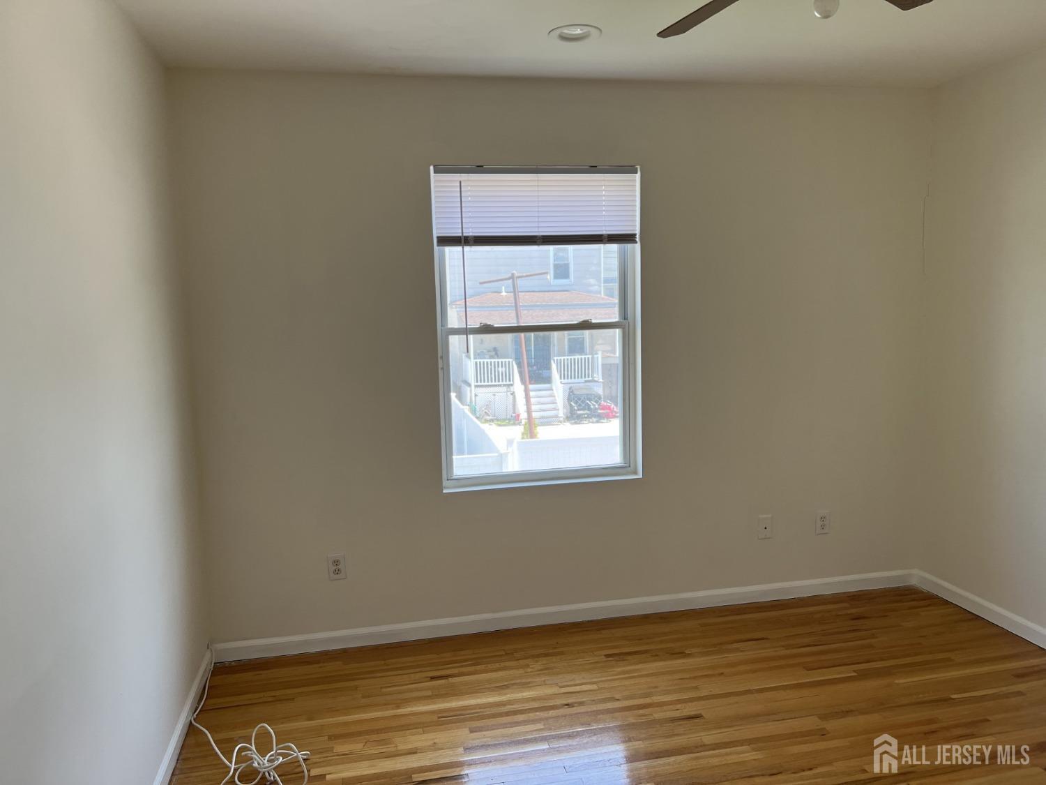22 North Whittier Street, Unit B Carteret, NJ 07008 - Photo 18 of 27 a view of room with window and wooden floor