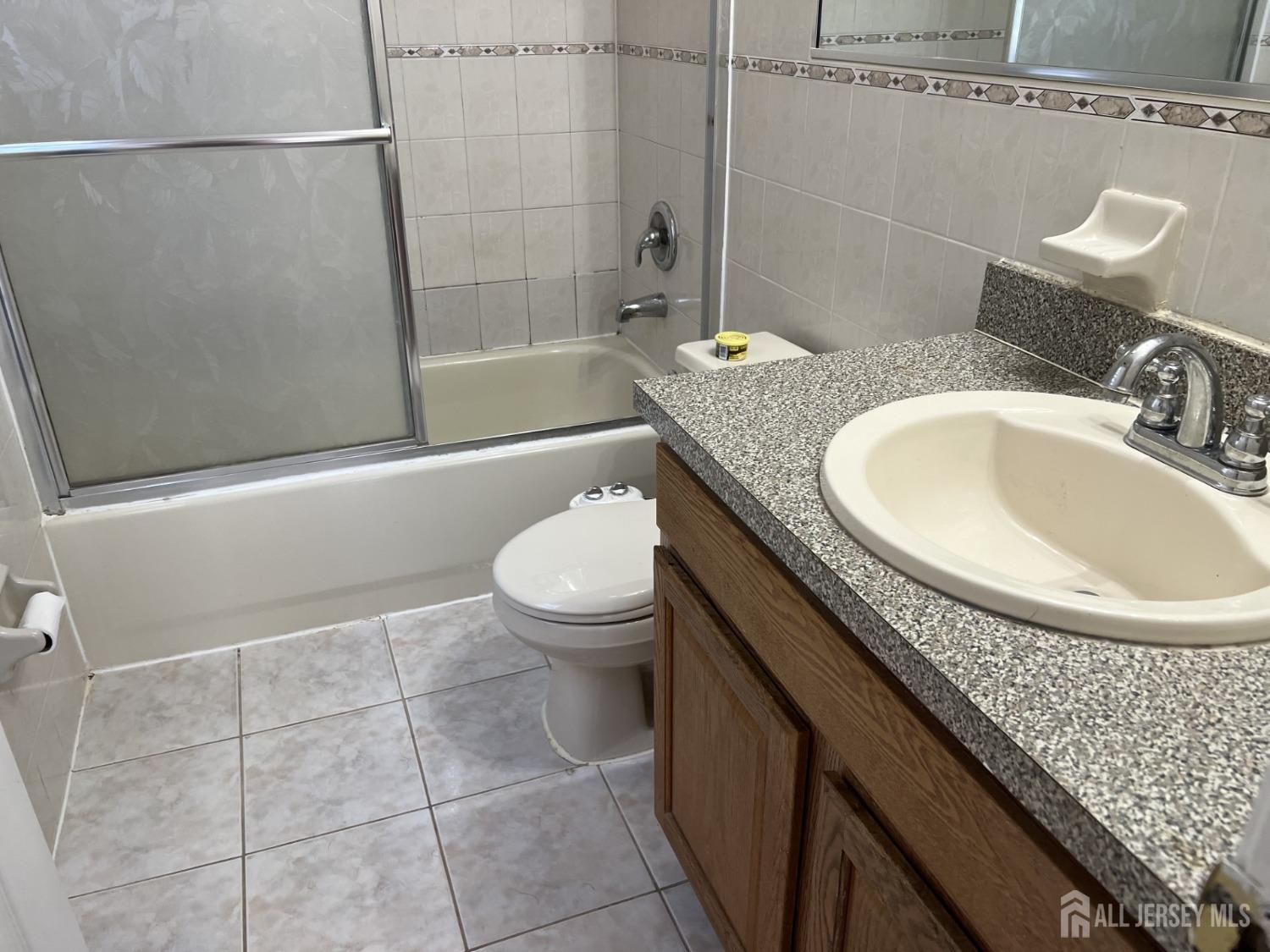 22 North Whittier Street, Unit B Carteret, NJ 07008 - Photo 24 of 27 a bathroom with a granite countertop sink a toilet and shower