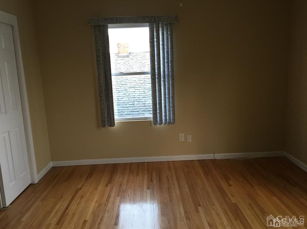 22 North Whittier Street, Unit B Carteret, NJ 07008 - Photo 9 of 27 a view of a room with wooden floor and a window