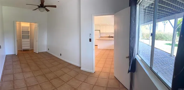 a view of an empty room and bathroom