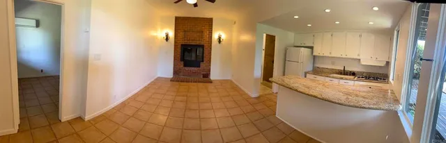 a bathroom with a granite countertop sink a mirror and shower