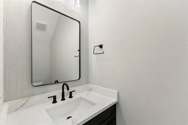 a view of a livingroom with a ceiling fan and wooden floor