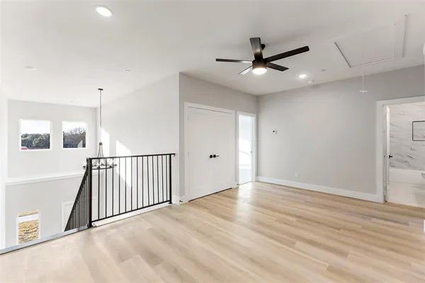 a view of a big room with wooden floor and windows in a room