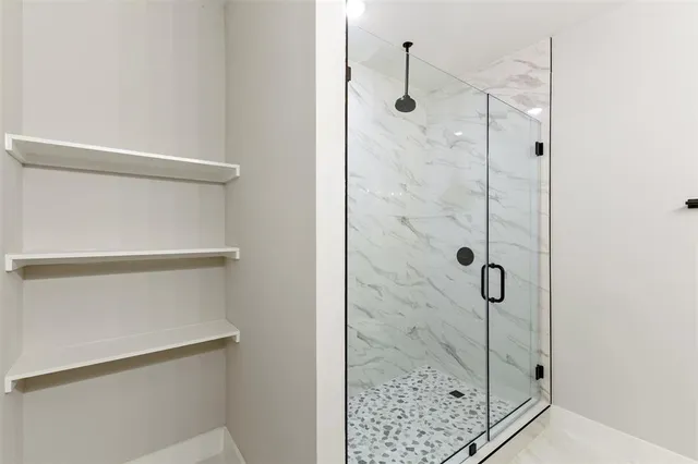 an empty room with windows and ceiling fan