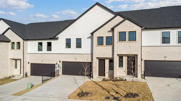 a view of a white house with large windows