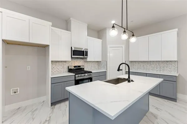 a kitchen with a stove and a microwave