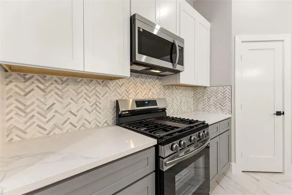a view of a kitchen with a sink and chandelier