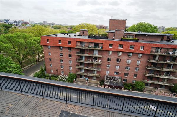 125 Pleasant Street, Unit 401 Brookline, MA 02446 - Photo 11 of 14 a view of a large building with a balcony