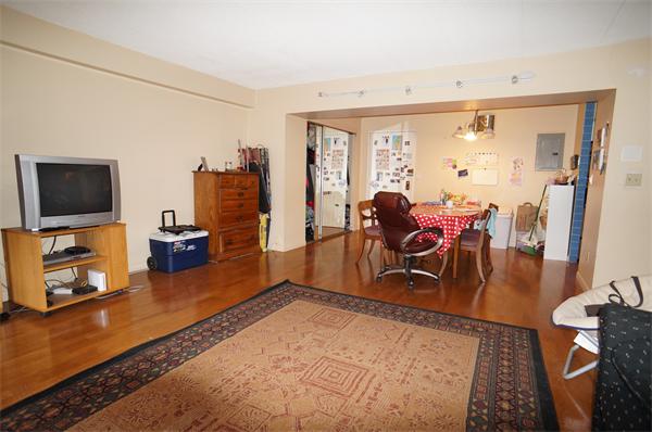 125 Pleasant Street, Unit 401 Brookline, MA 02446 - Photo 3 of 14 a living room with furniture and a flat screen tv