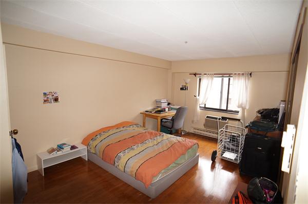 125 Pleasant Street, Unit 401 Brookline, MA 02446 - Photo 5 of 14 a bedroom with a bed and wooden floor