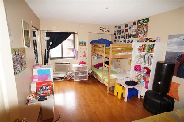 125 Pleasant Street, Unit 401 Brookline, MA 02446 - Photo 6 of 14 a living room with furniture and toys