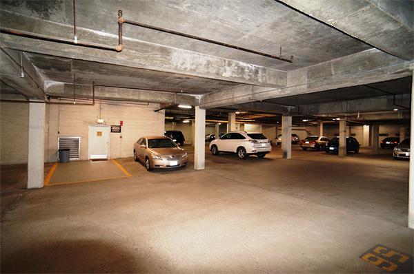 125 Pleasant Street, Unit 401 Brookline, MA 02446 - Photo 9 of 14 a view of parking garage with cars