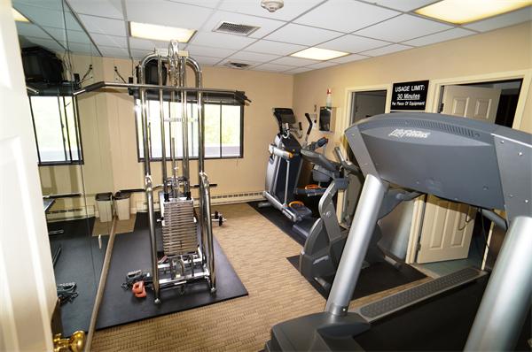 125 Pleasant Street, Unit 401 Brookline, MA 02446 - Photo 10 of 14 a view of a room with gym equipment