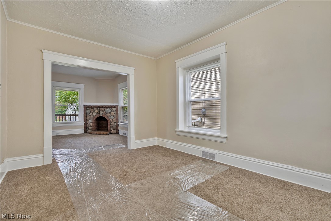 796 Dayton Street Akron, OH 44310 - Photo 11 of 25 Bright interior room featuring a wide arched entryway and a window with blinds