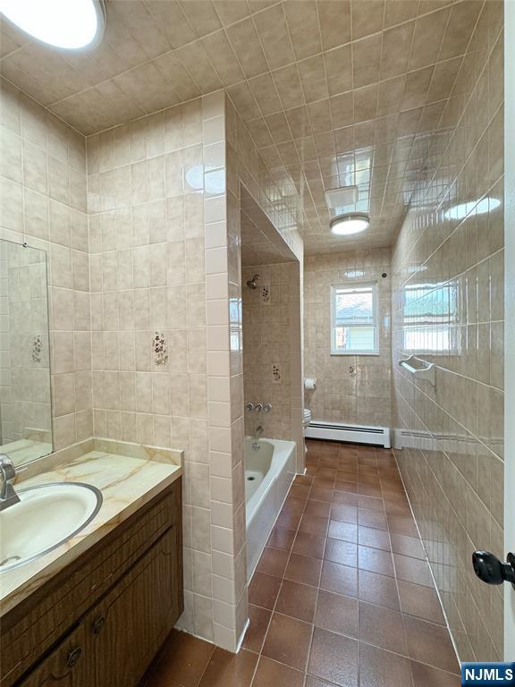 141 Westervelt Place, Unit 2 Lodi, NJ 07644 - Photo 8 of 10 a bathroom with a granite countertop sink a toilet and shower