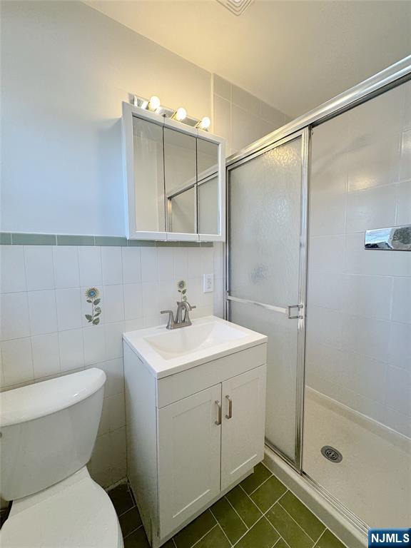 141 Westervelt Place, Unit 2 Lodi, NJ 07644 - Photo 9 of 10 a bathroom with a sink toilet and shower