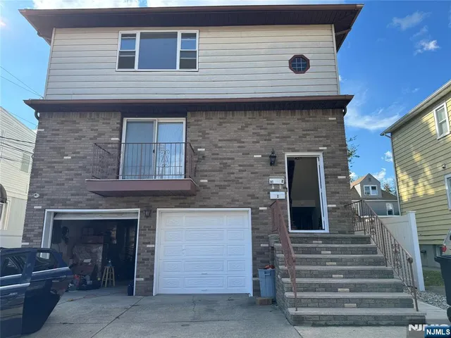 a front view of a house with stairs