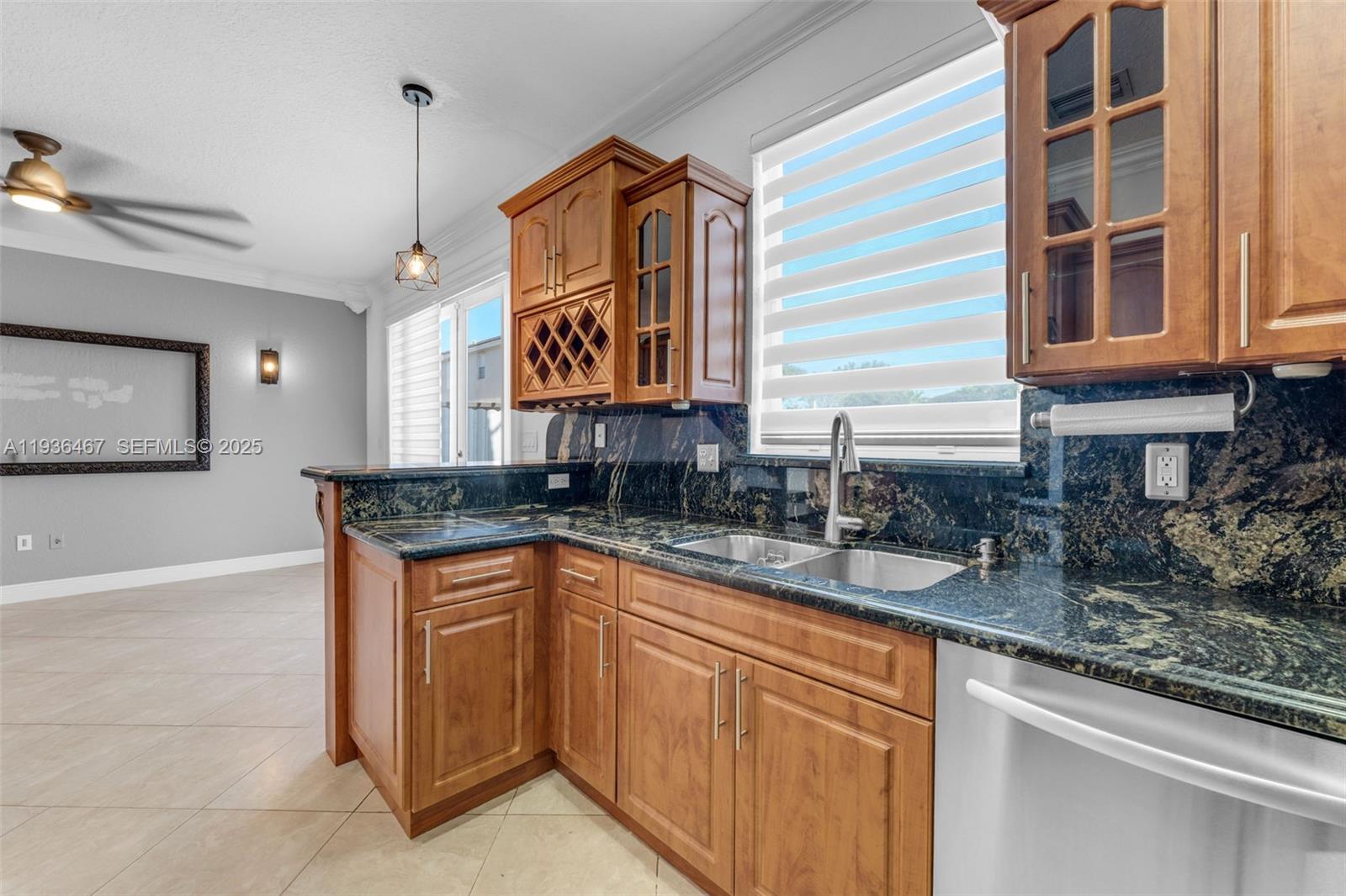 851 Southwest 154th Path, Unit 851 Miami, FL 33194 - Photo 16 of 45 a kitchen with granite countertop a sink and a stove