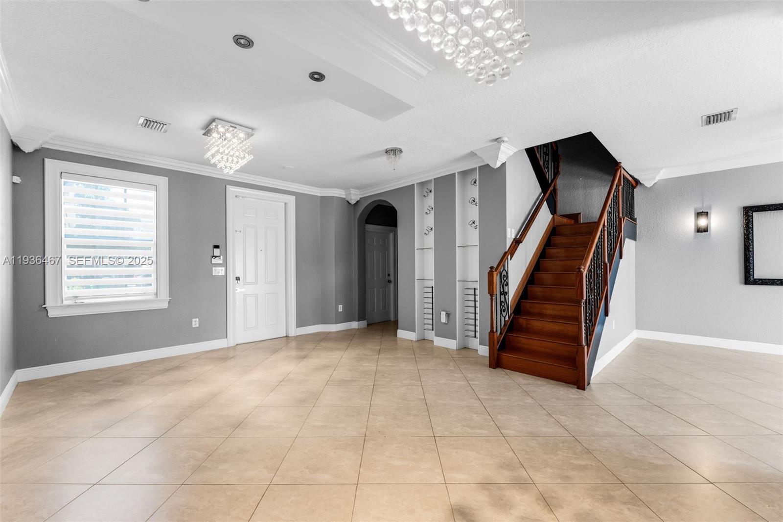 851 Southwest 154th Path, Unit 851 Miami, FL 33194 - Photo 20 of 45 a view of an empty room with stairs and a chandelier fan