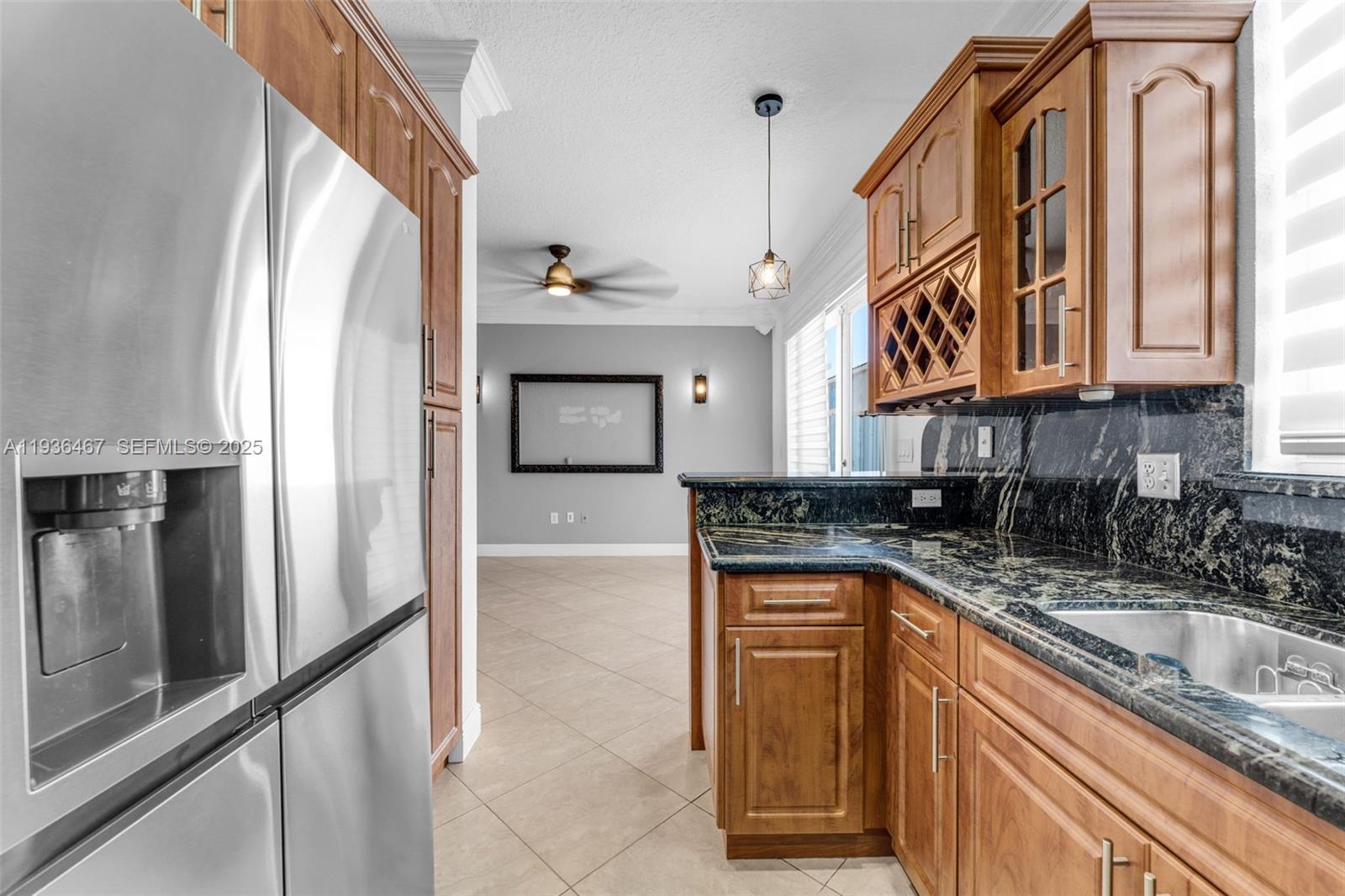 851 Southwest 154th Path, Unit 851 Miami, FL 33194 - Photo 2 of 45 a kitchen with granite countertop a sink a stove and cabinets