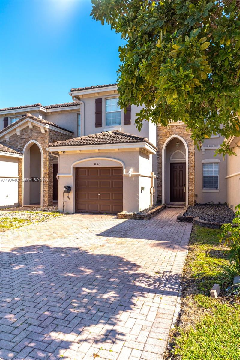 851 Southwest 154th Path, Unit 851 Miami, FL 33194 - Photo 23 of 45 a front view of a house with a yard