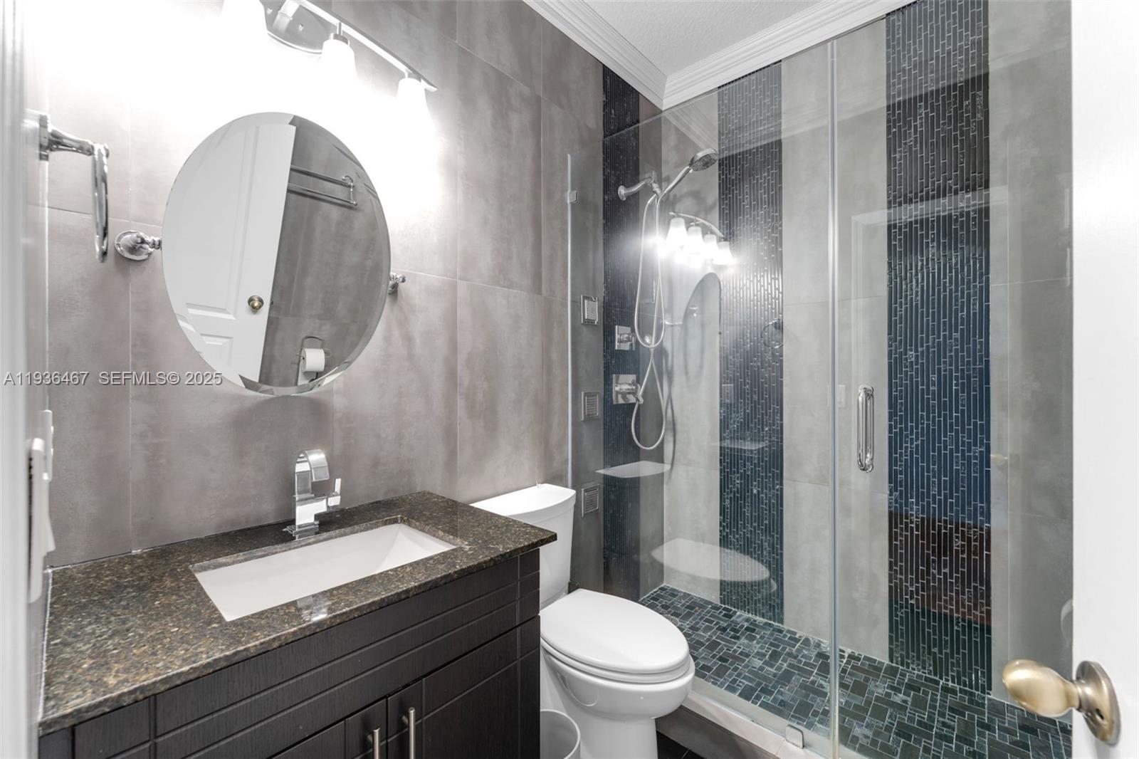 851 Southwest 154th Path, Unit 851 Miami, FL 33194 - Photo 3 of 45 a bathroom with a granite countertop sink a toilet and shower