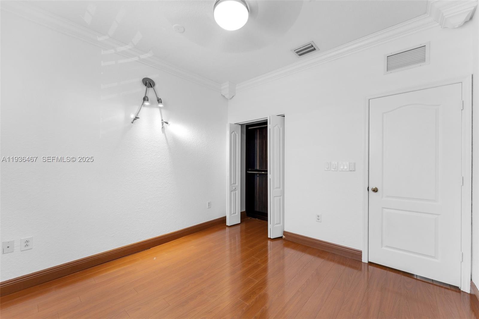 851 Southwest 154th Path, Unit 851 Miami, FL 33194 - Photo 37 of 45 wooden floor in an empty room