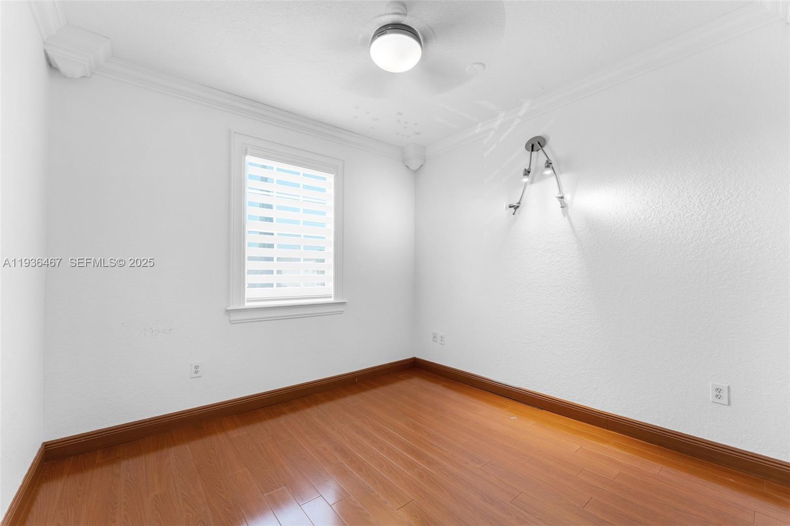 851 Southwest 154th Path, Unit 851 Miami, FL 33194 - Photo 38 of 45 wooden floor in an empty room with a window