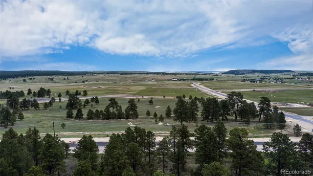 a view of a lake with houses in back