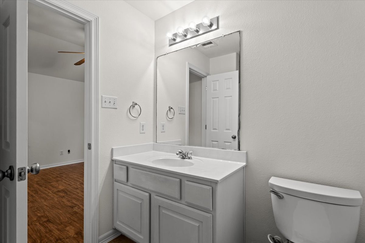 2304 Village View Loop Pflugerville, TX 78660 - Photo 40 of 40 Functional vanity and bright mirror illuminate this well-appointed bathroom space.