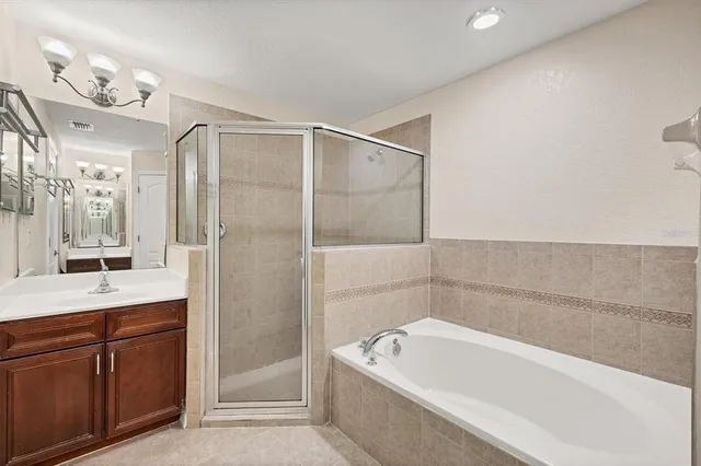 a view of a room with wooden floor fan and windows