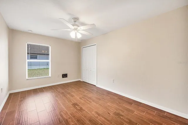 wooden floor in an empty room with a window