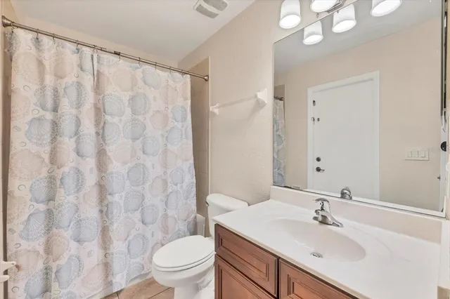 a aerial view of a house with swimming pool and large trees