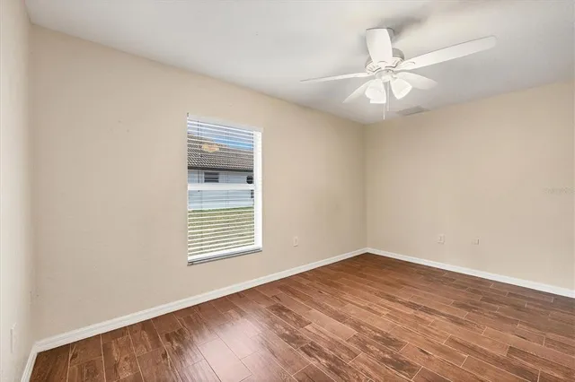 a front view of yellow house with a yard