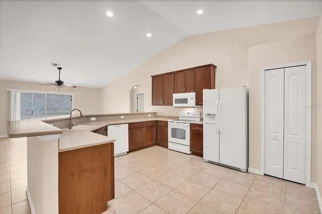 a kitchen with stainless steel appliances granite countertop a sink and stove top oven