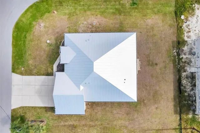 a view of a house with a yard and lake view