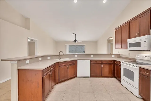 a view of kitchen cabinets and stainless steel appliances