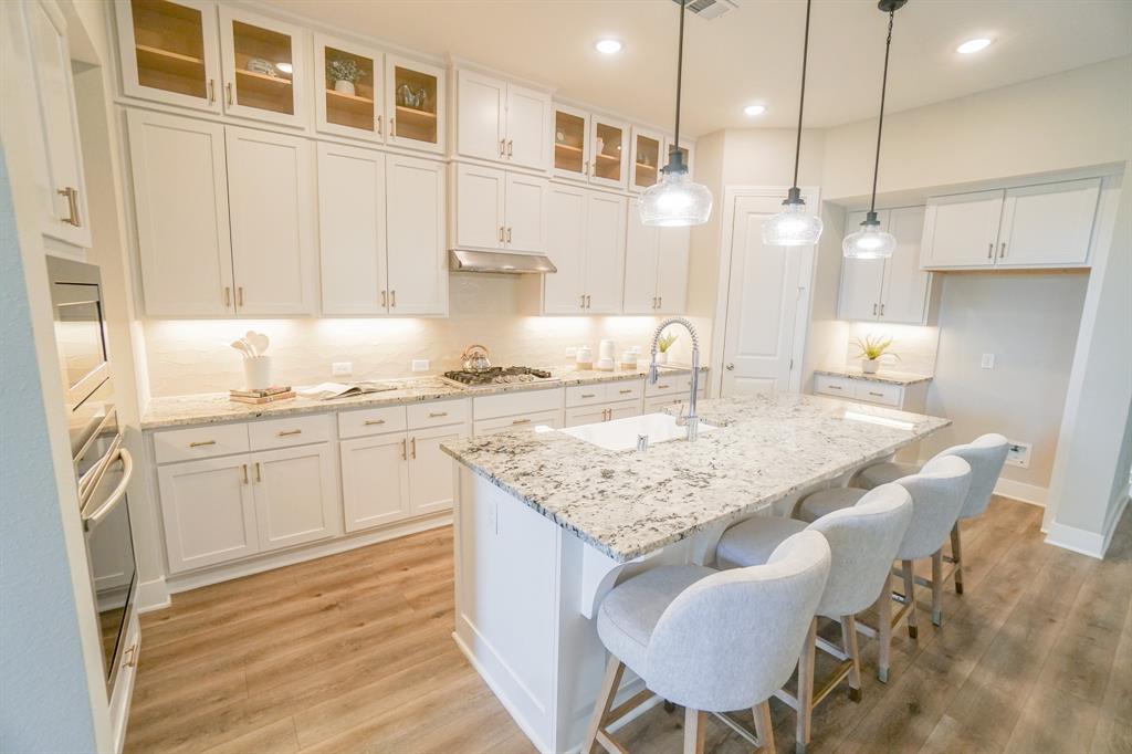 1309 Old Rocksprings Pass Mansfield, TX 76063 - Photo 1 of 36 Contemporary kitchen featuring an oversized island with a built-in sink and pendant lighting